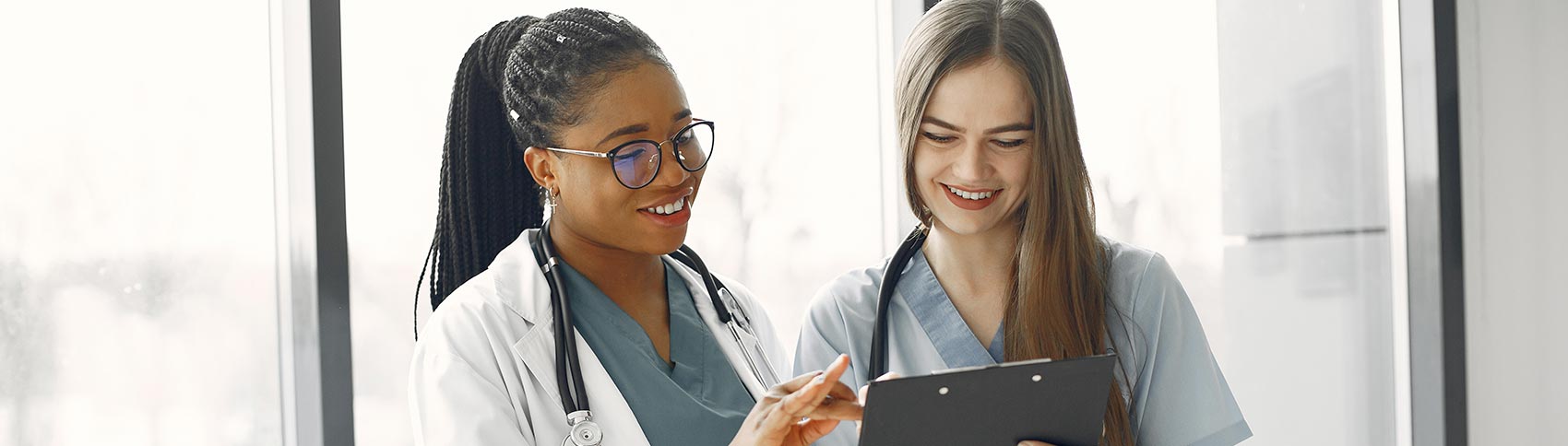 A doctor looks over a chart with a nurse